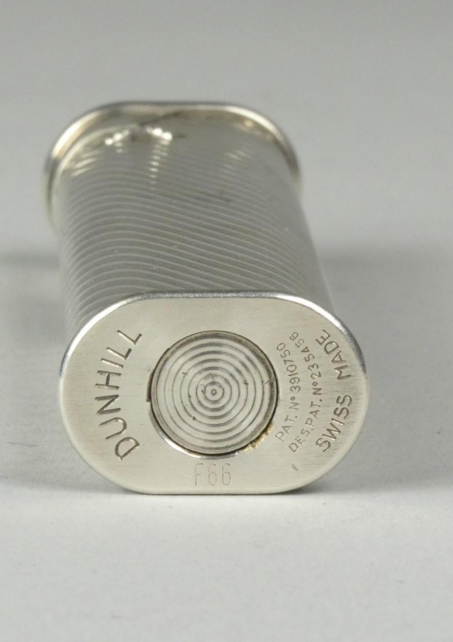 A Dunhill white metal roller lighter with reeded decoration, signed Dunhill F66, length 7cm - Image 3 of 3