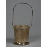 A silver sugar pail, Birmingham 1930, of plain form with hoop handle, lacking spoon, glass liner,