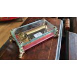 A music box by Reuge of Switzerland, with glass panels and gilt mounts, playing The Thieving Magpie,