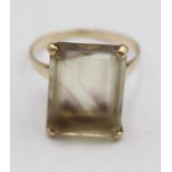 A 9ct gold and smokey quartz dress ring, London 1966, claw set with a step cut stone, 17 x 12 cm,