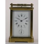 A brass carriage striking, repeating and alarm clock, the white enamel dial unsigned, subsidiary