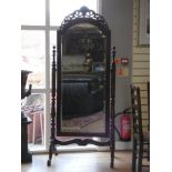 A mahogany cheval mirror, the bevel edge glass with pierced arched pediment, turned supports, 190