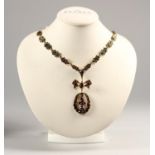 An Austrian silver gilt Bohemian garnet cluster necklace, bearing 900 standard control marks, to a