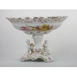 A 19th century continental pedestal dish, the lift off cover with two cherubs and fruit, similar