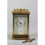 An English brass carriage timepiece, the white enamel dial signed St. James, London, the 11 jewel