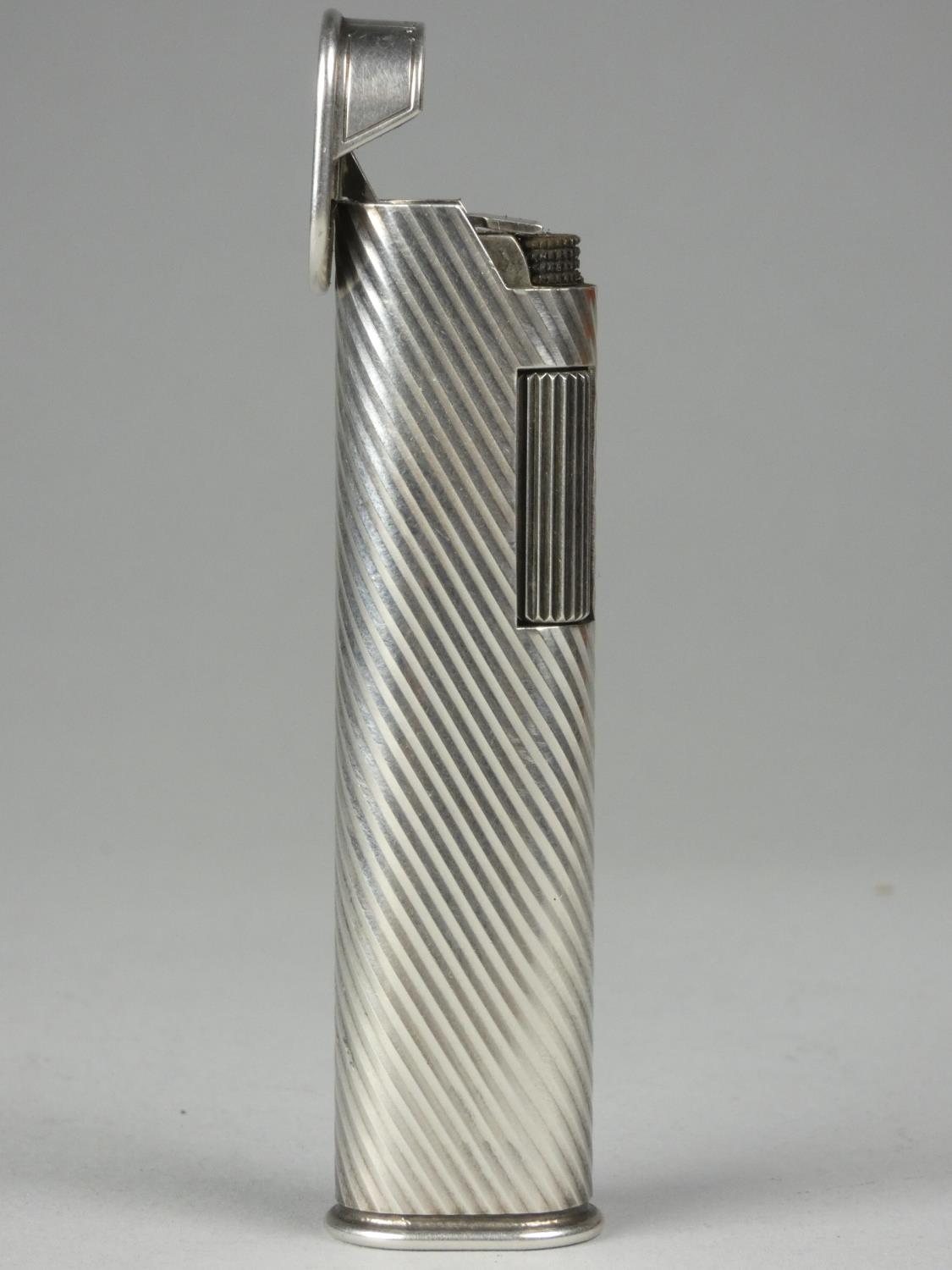 A Dunhill white metal roller lighter with reeded decoration, signed Dunhill F66, length 7cm - Image 2 of 3