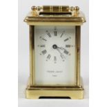 A French brass carriage time piece, the white enamel dial signed Pierre Jacot, Paris, height with