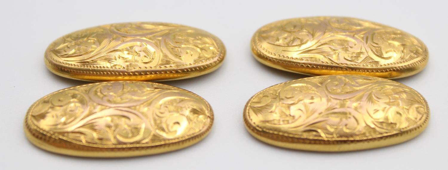 A pair of oval 9ct rose gold cufflinks, Birmingham 1919, with engraved decoration, 3 gms.