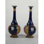 A pair Doulton Lambeth stoneware vases, by Maud Bowden, pattern 8832, with slender necks,