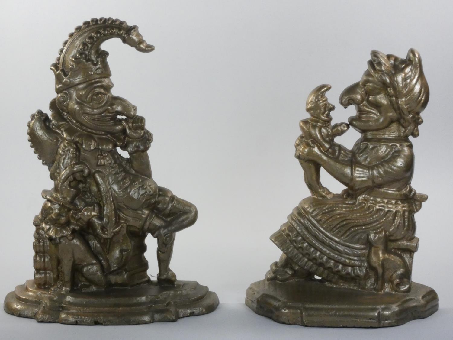 A cast iron pair of door stops, in the form of Punch and Judy, later painted, 32 cm.