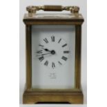 A brass carriage time piece, the white enamel dial signed Dent, Pall Mall, London, height with
