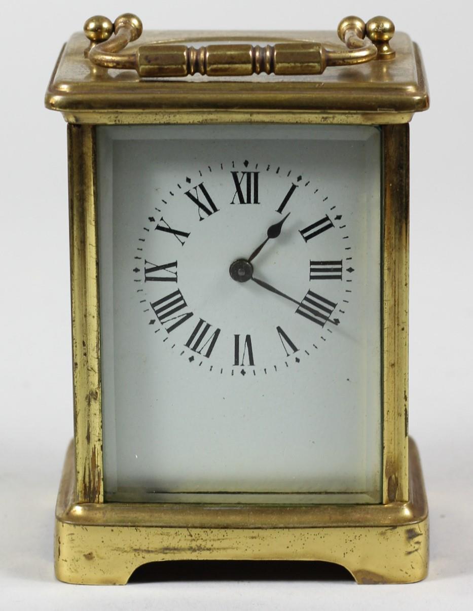 A French brass carriage time piece, the white enamel dial unsigned, the movement stamped Made in