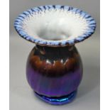 Antony Sterne, an iridescent purple vase of baluster form, studded neck, scalloped and flared rim,