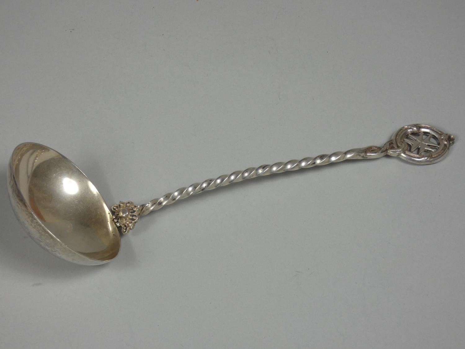 A Maltase silver ladle, bearing control marks point 875 standard with twist stem and Maltase cross
