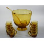 A hand blown amber glass punch bowl, ladle and ten cups, c. 1960/70, unsigned, diameter 25 cm