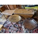 An oak drop leaf dining table and 3 other tables