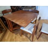 A GPlan drop leaf dining table (lacking one leaf), together with four dining chairs