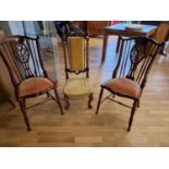 A Victorian walnut nursing chair and a pair of Edwardian mahogany hall chairs