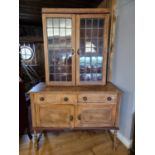 A stripped oak bookcase cabinet marriage, the leaded doors over a side cabinet.