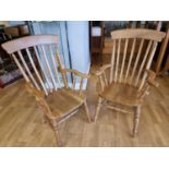 \a pair of beech high back armchairs with shaped arms, 110 cm.