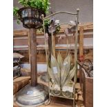 A pair of plated plant stands together with a floral umbrella stand, candlestick holders and glass