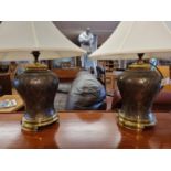 A pair of brass and bronzed table lamps with shades, total height 89cm