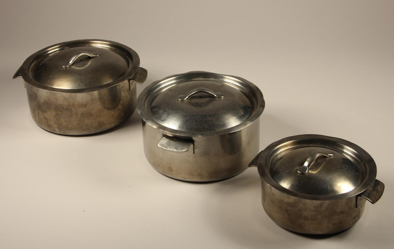 Three stainless steel cooking pots, each marked to base and lid 'LMS HOTELS'