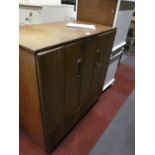 A 1970's teak Hi-Fi cabinet with hinged top to reveal a fitted interior for LP storage 84cm wide