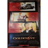 A James Bond 'Golden Eye' theater poster together, with James Bond videos, a collection of DVDs, a