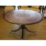 A circular mahogany dining table with inset leather skiver,148 cm diameter