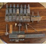 A quantity of early woodmakers tools including block planes, slide rule, spirit level, grinding