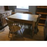 A stripped kitchen table together with four matching dining chairs and a stripped pine dresser 196