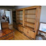 A set of three solid oak freestanding open bookshelves with 2 door cupboard below (3)