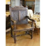 An early 20th Century oak carved hall chair. seat height 47, height 113 cm.