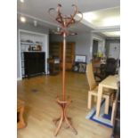 A bent wood coat stand 195 cm tall