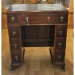 An 19th century mahogany knee hole campaign desk, with lift up compartment and various drawers, 64 x