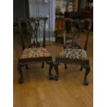 A set of four quality Chippendale-style dining chairs with tapestry seats on claw & ball feet (4)