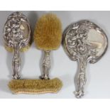 An Art Nouveau silver 4 piece dressing table set, Birmingham 1909, with embossed floral decoration