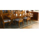 A yew-wood twin pedestal extending dining table, the rectangular top with cut corners, burr yew