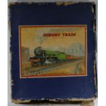 A clockwork Hornby O gauge no.601 tinplate L.M.S goods train set: L.M.S maroon 0-4-0 loco and tender