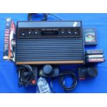 An Atari 2600 games console model number CX-2600 U (woody) SNo 548149618 to include power supply,