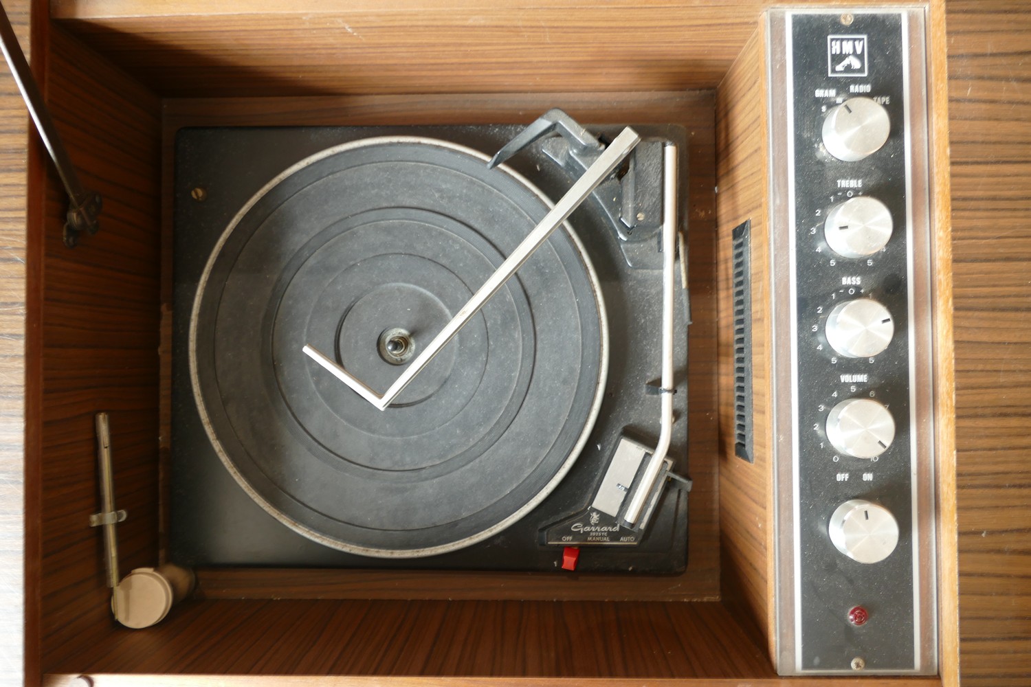 A HMV with integrated Garrard deck, model number 2025TC, cabinet record player, 50cm tall, 68cm