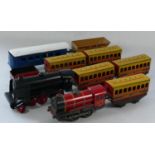 A collection of tin plate model railway to include- two unmarked locomotives, five first class