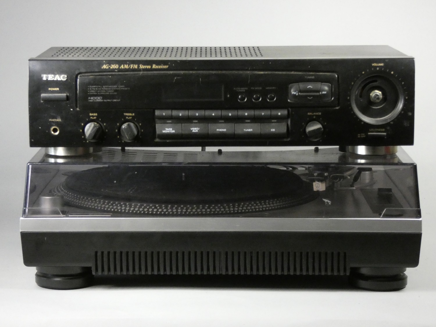 An mid 2000's Homemix TT1000 turntable, together with a Teac AG-260 Stereo receiver with a missing