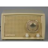 A Champion small plastic cased radio in cream. Turns on and buzzes. MW/LW volume and tuning. 4