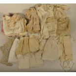 A collection of assorted 19th century and later doll clothes to include- dresses and bonnets,