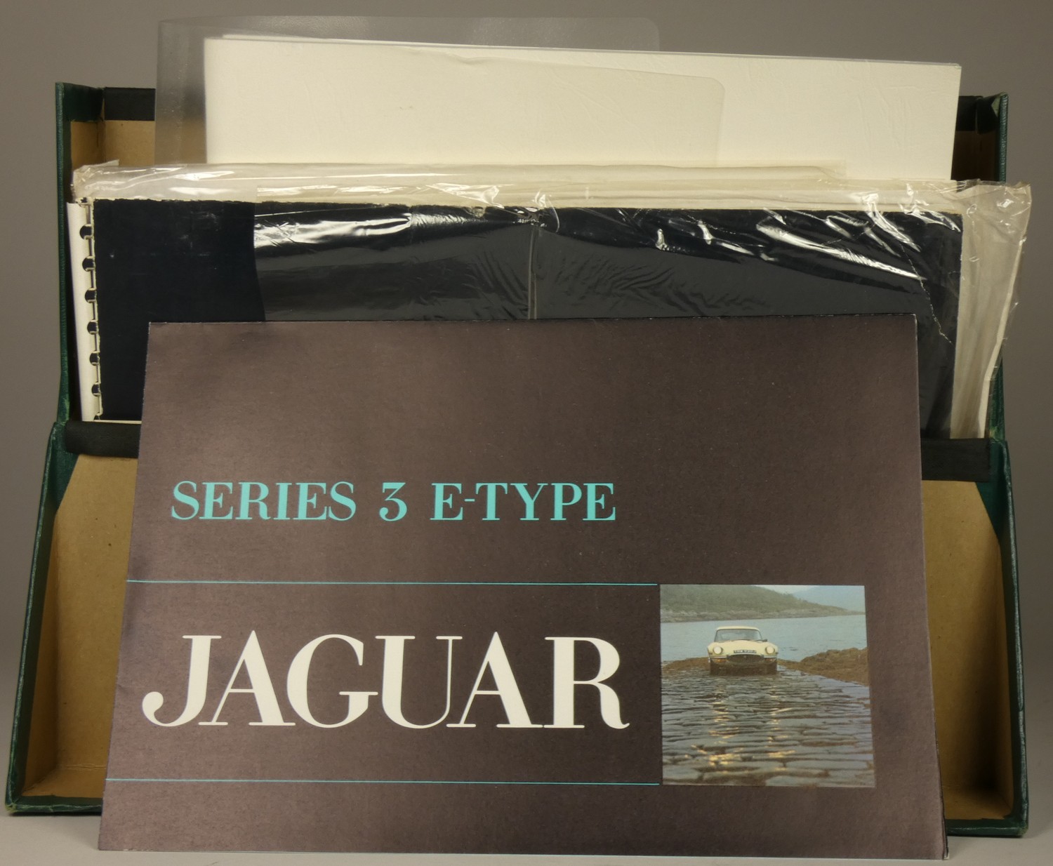 A collection of car brochures and booklets, mainly Jaguar, including Jaguar XJ6, series 3 E-type and