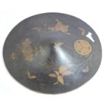 A Japanese Jingasa (travelling hat) of circular form, finished in black lacquer with a gold