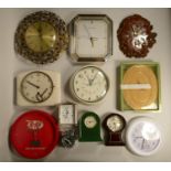 A box of clock spares together with quartz wall clocks