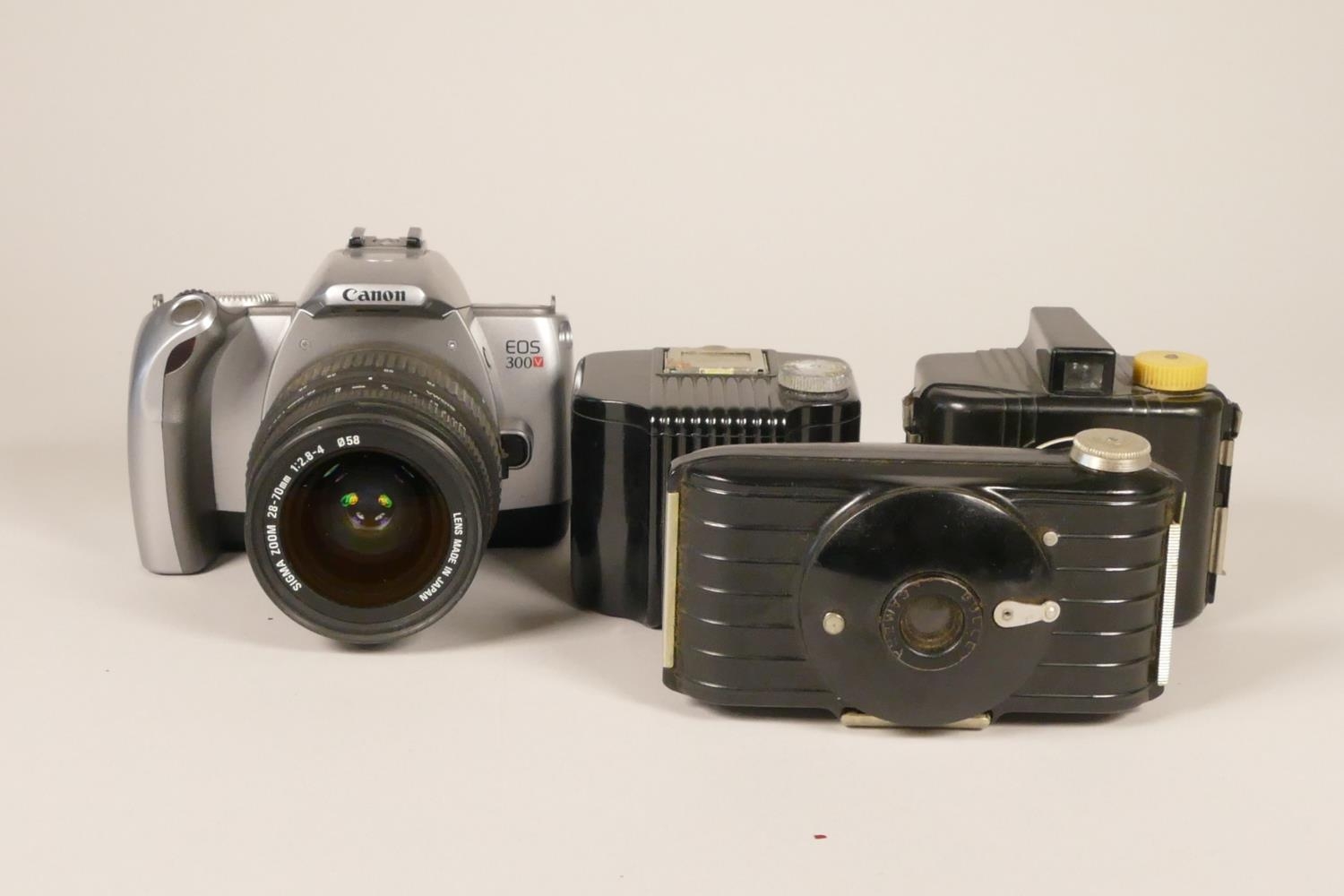 A Canon EOS 300V SLR Film Camera w/ Sigma 28-70mm F/2.8-4 Lens, together with a Kodak Bullet